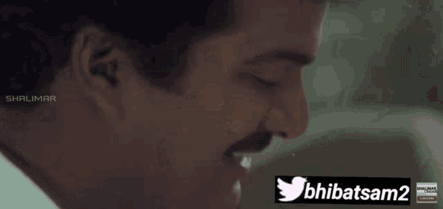 a close up of a man 's face with a twitter icon next to him