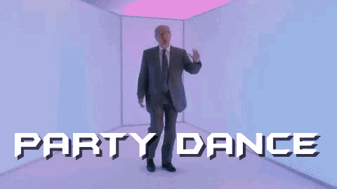 a man in a suit and tie is dancing in front of a sign that says `` party dance '' .