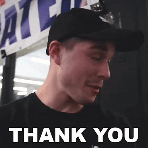 a man wearing a black hat and a black shirt says " thank you "