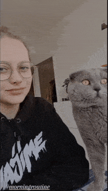 a woman wearing a black hoodie that says i love mine