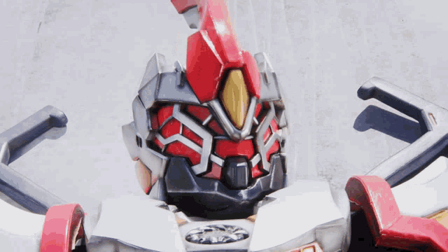 a close up of a robot 's head with a red and white helmet