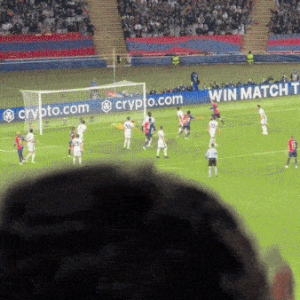 a soccer game is being played in front of a banner that says win match t