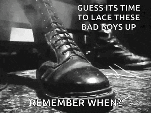 a black and white photo of a person wearing a pair of black boots with the caption guess its time to lace these bad boys