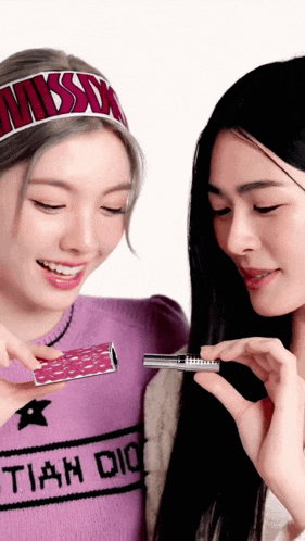 a woman wearing a headband that says misson is looking at a lipstick
