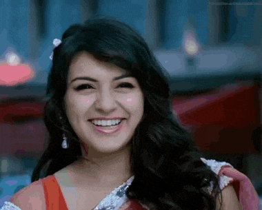 a close up of a woman 's face with a smile on it