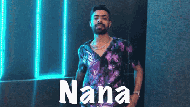 a man in a purple shirt with nana written on the bottom