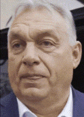 a close up of a man 's face with a suit and tie