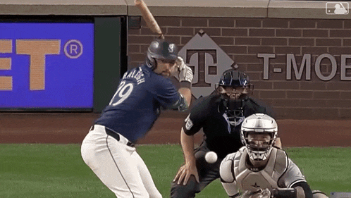 a baseball player with the number 19 on his jersey swings at a ball