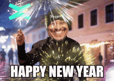 a man holding a sparkler with the words happy new year written on it