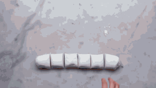 a bottle of gel food coloring is being applied to a white item