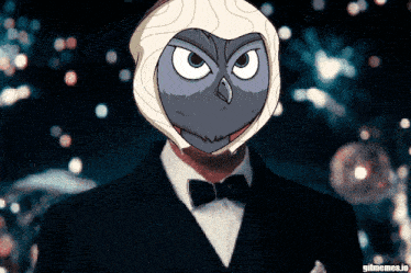 a man in a tuxedo has an owl mask on his head