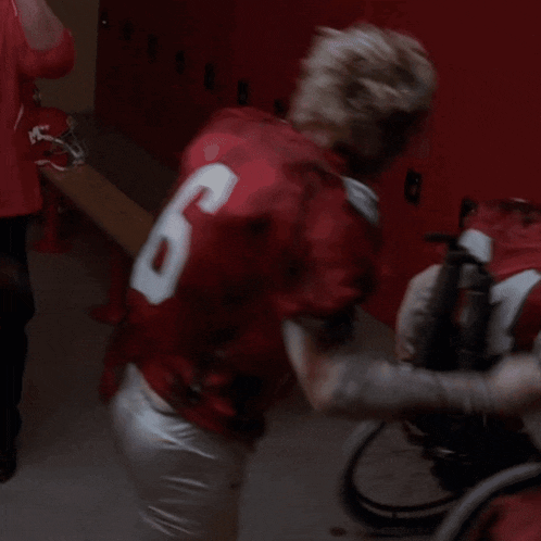 a football player in a red uniform with the number 6 on it
