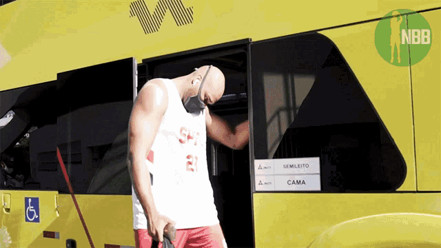 a man wearing a mask stands in front of a bus that says cama
