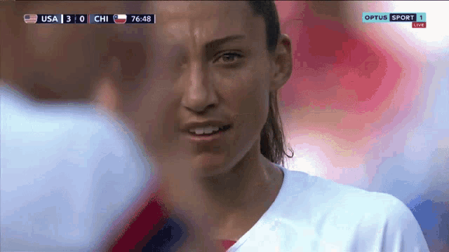 a close up of a woman 's face during a soccer game between usa and chi