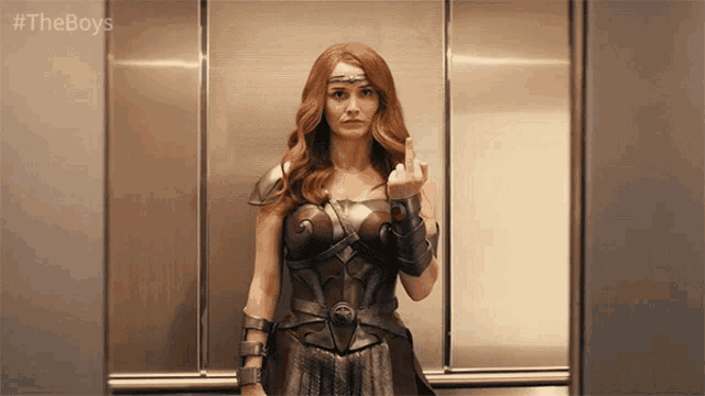 a woman in a superhero costume is giving the middle finger in an elevator
