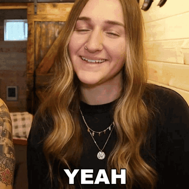 a woman with her eyes closed is smiling with the word yeah above her head