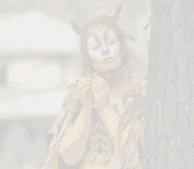 a woman with her face painted like a deer