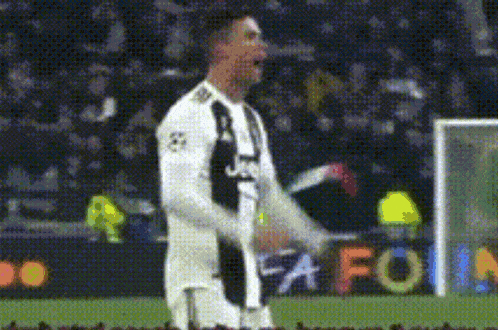 a soccer player wearing a juventus jersey is standing on the field .
