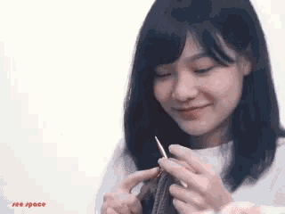 a woman is knitting and the words see space are on the bottom left