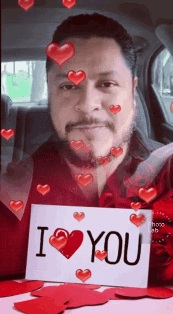 a man is holding a sign that says " i love you "
