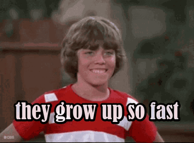 a young boy in a red and white striped shirt is smiling and says they grow up so fast