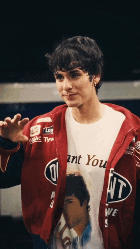 a man wearing a red jacket and a white shirt that says " i want you "