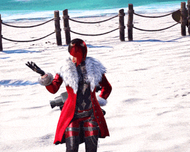 a woman in a red coat with a fur collar stands on a beach