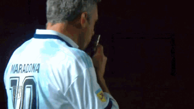 a man wearing a number 70 maradona jersey