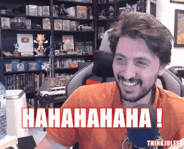a man with a beard is smiling in front of a sign that says ' hahahahaha ! '