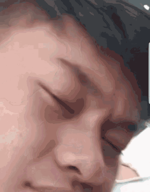 a close up of a person 's face with his eyes closed