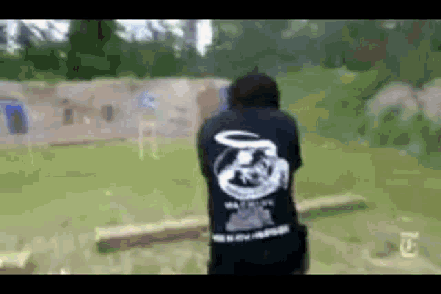 a person wearing a black shirt with a snake on the back