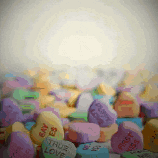 a pile of candy hearts with one that says true love on it