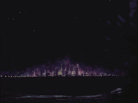 a city skyline at night with a purple sky