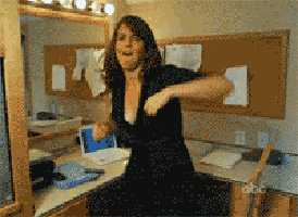 a woman in a black dress is dancing in front of a mirror