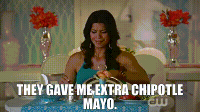 a woman is sitting at a table with a plate of food .
