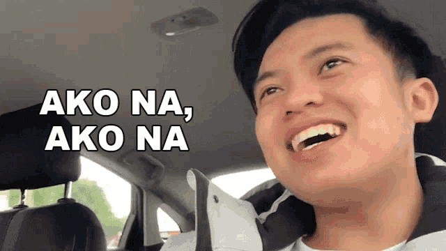 a man sitting in a car with the words ako na ako na written above him