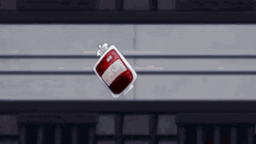 a man is being attacked by a red monster in front of a large building