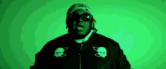 a man wearing sunglasses and a bandana has two skulls on the sleeves of his jacket