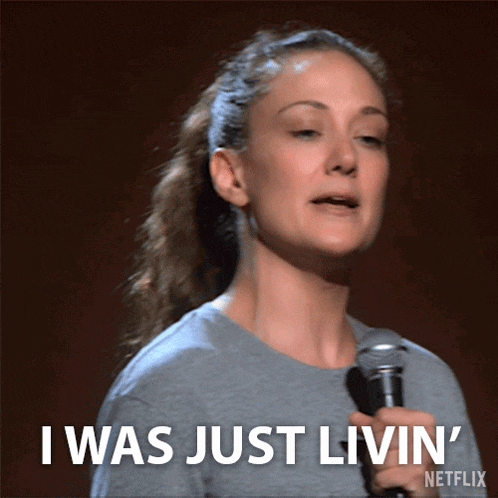 a woman holding a microphone and saying i was just livin