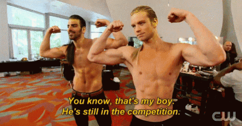a shirtless man flexes his muscles next to another shirtless man who says " you know that 's my boy