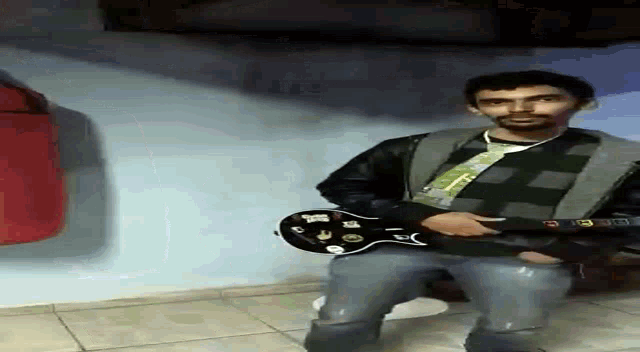 a man in a plaid jacket is holding a guitar with stickers on it