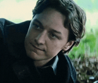 a close up of a man 's face with a slight smile on his face