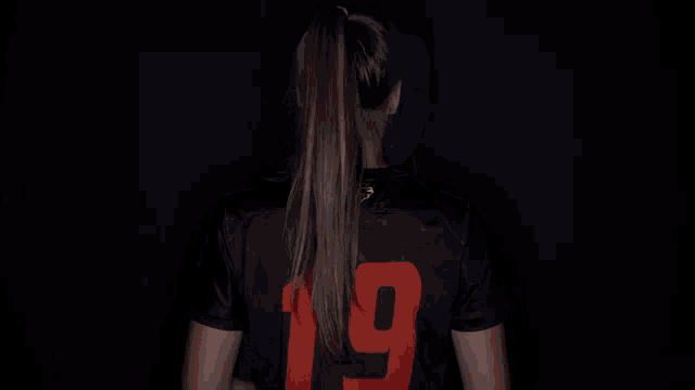 a girl wearing a jersey that says campbell 19 on it