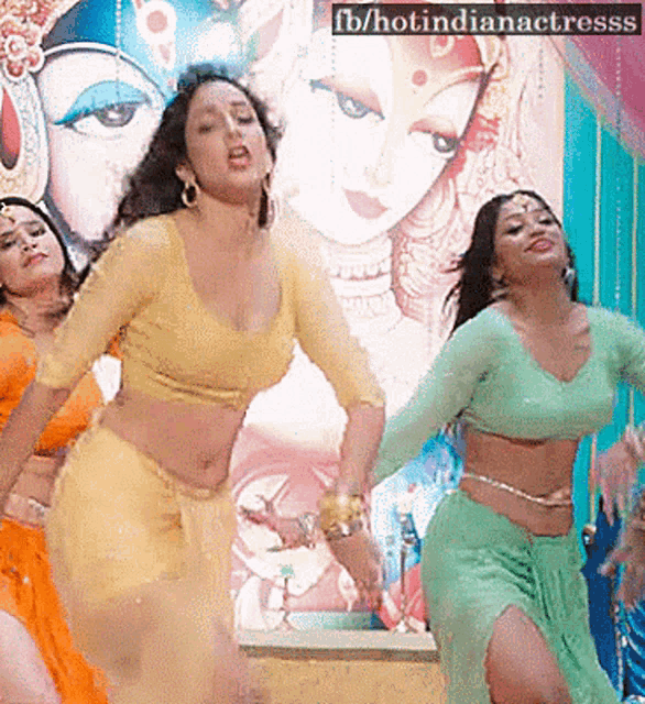 a group of women are dancing in front of a poster that says fb / hotindianactresss on it