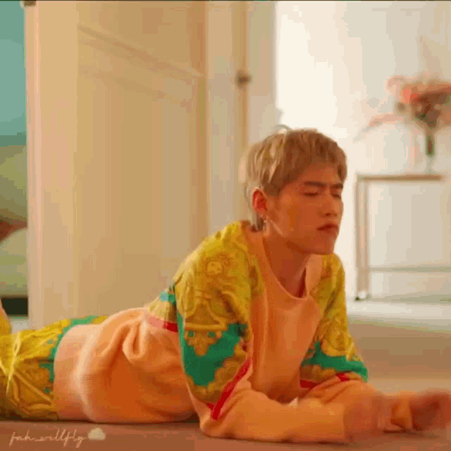 a man is laying on the floor with his legs crossed .
