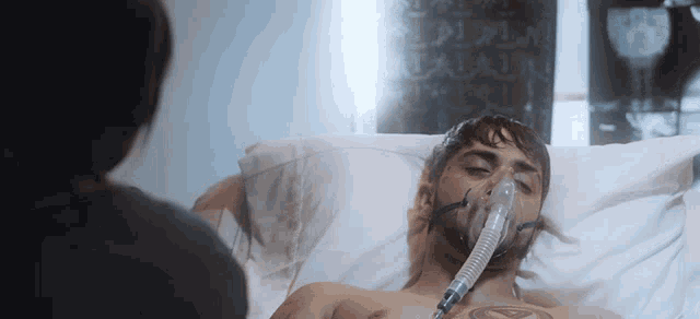 a man in a hospital bed with an oxygen mask on