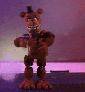 a stuffed teddy bear is standing on a cutting board
