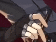 a close up of a person 's hand with rings on it holding a gun .