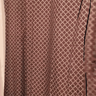 a close up of a shower curtain with a pattern