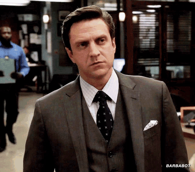 a man in a suit and tie has barbabot written on the bottom